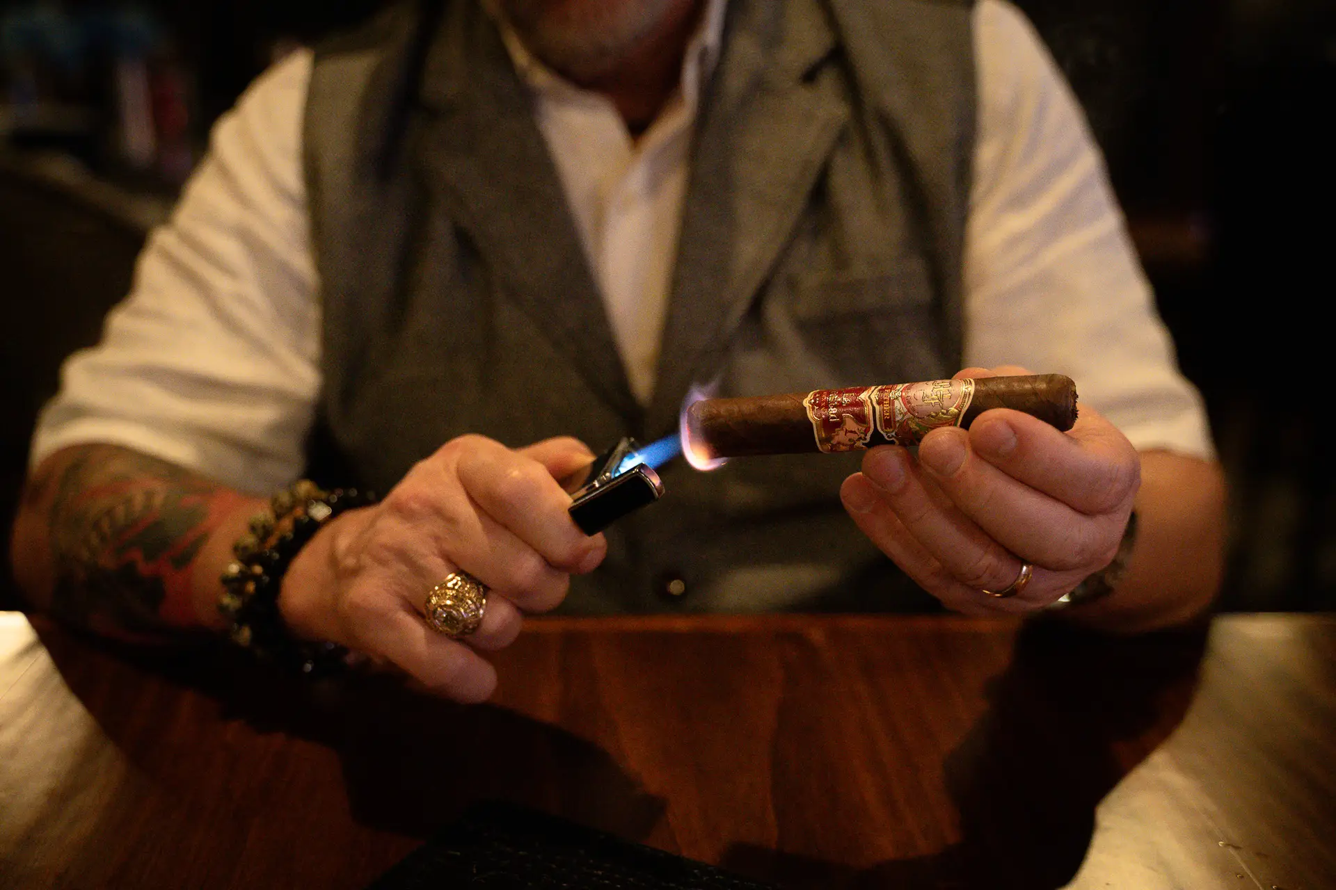 Cigar lighting in Ember & Vine in Spring, TX