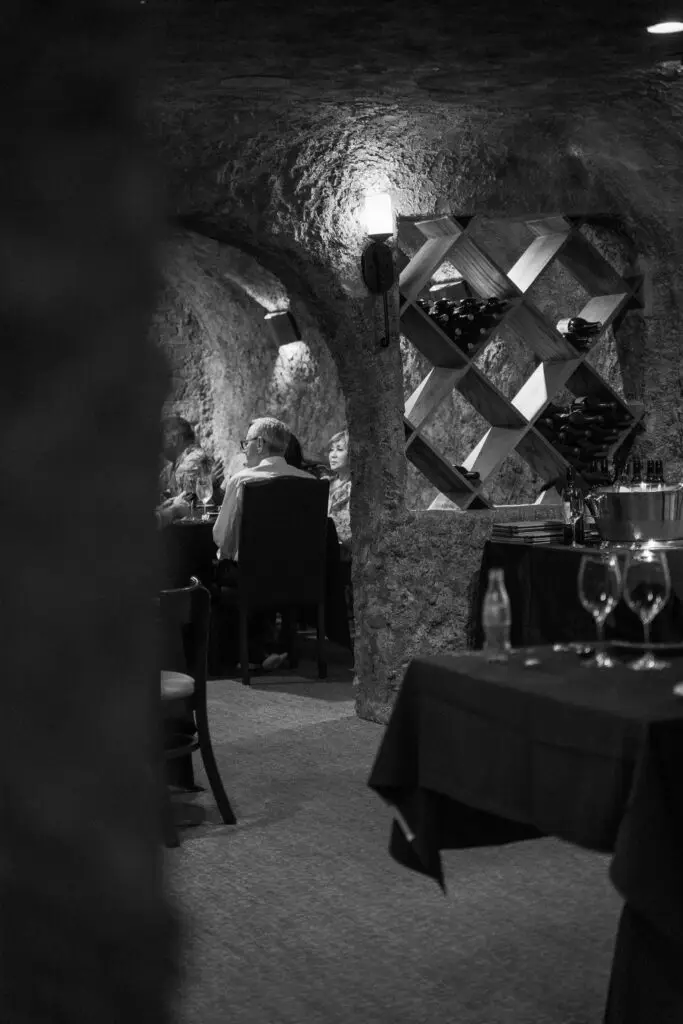 Guests dining in the Vine Room wine cellar at Ember & Vine in Spring, Texas