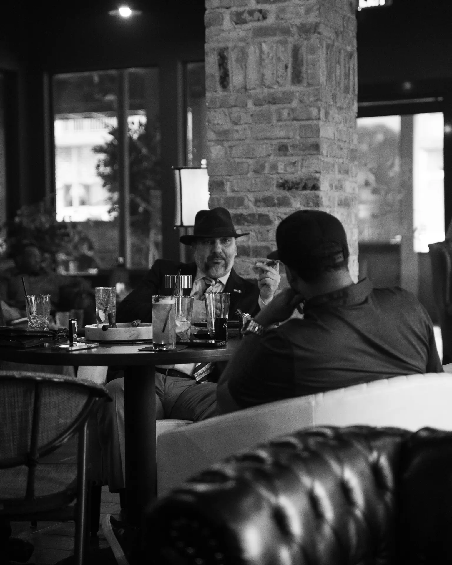 gentlemen smoking cigar in the Ember & Vine cigar lounge